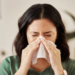 Woman blowing her nose
